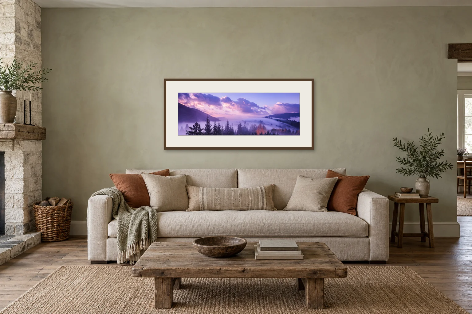 Illustrative interior mockup: a 100 cm forest panorama in a dark oak frame with a 10 cm ivory mat, centered above a linen sofa in a country sitting room.