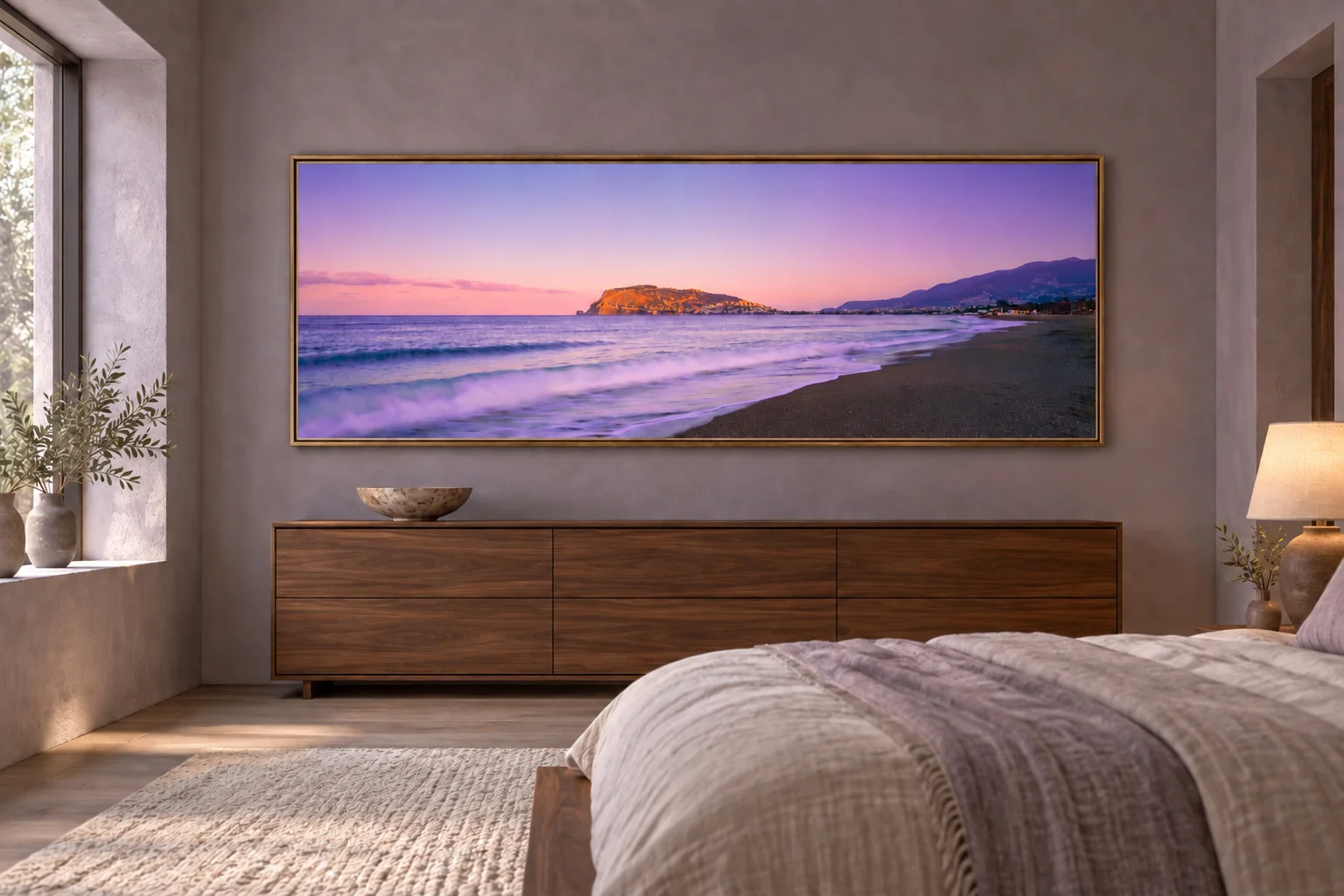 Illustrative mockup of the golden headland panorama in a bronze frame above a walnut dresser in a lavender-grey bedroom with flax linen.