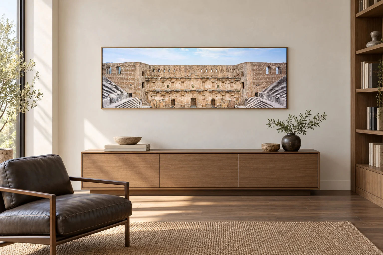 Illustrative mockup of the theatre panorama in a bronze frame above an oak credenza in an ivory study with a charcoal leather chair.