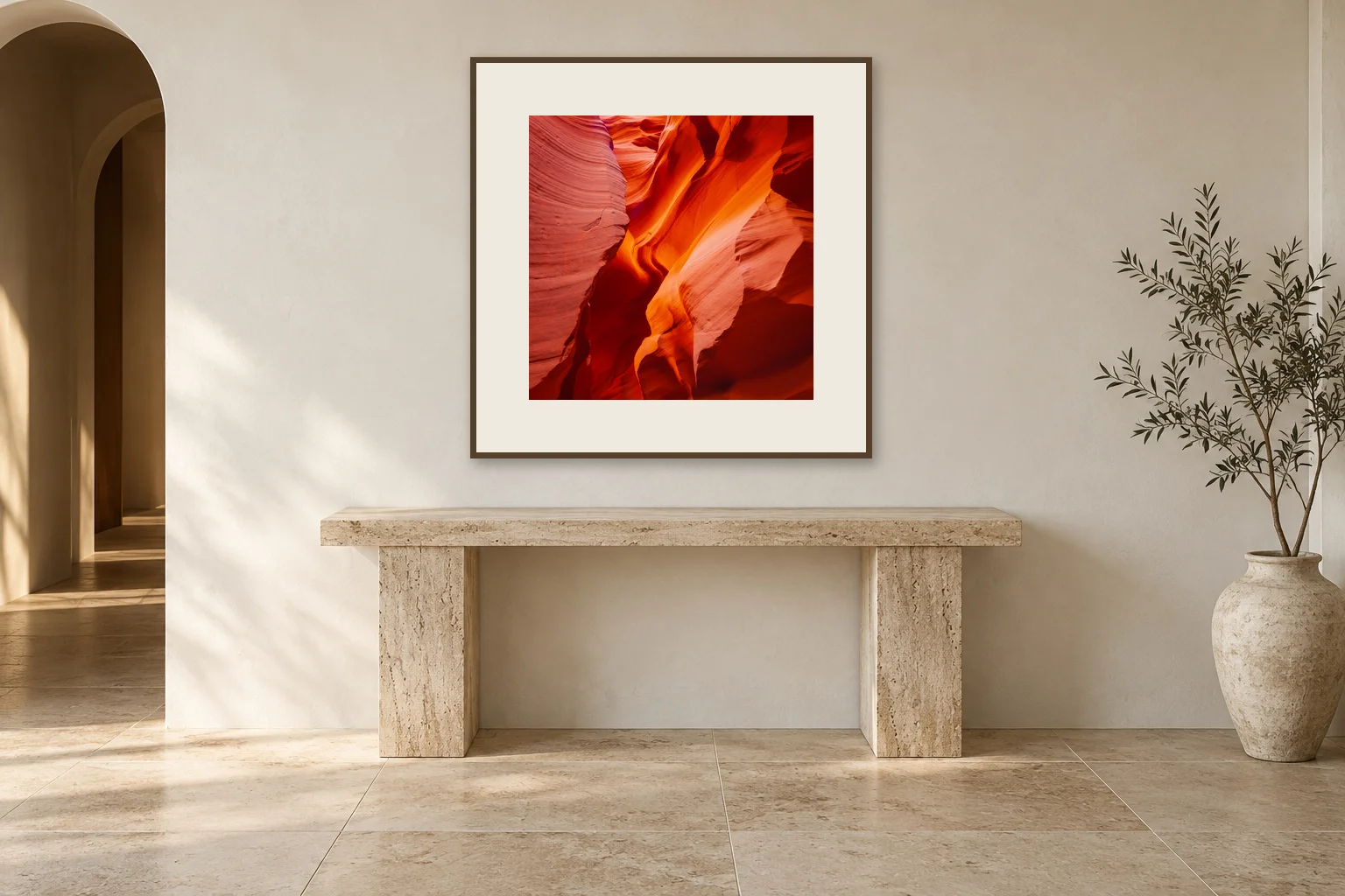 Illustrative mockup: Folds of Fire, a 65 × 65 cm photograph with a 12 cm ivory mat and oak frame, centered above a travertine console.