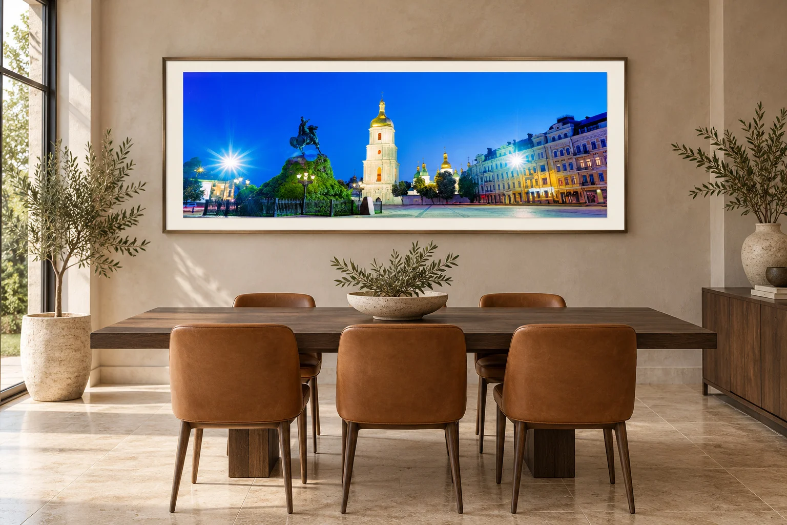 Illustrative generated mockup: the blue-and-gold square panorama in a bronze frame above a smoked-oak dining table in a greige contemporary dining room.